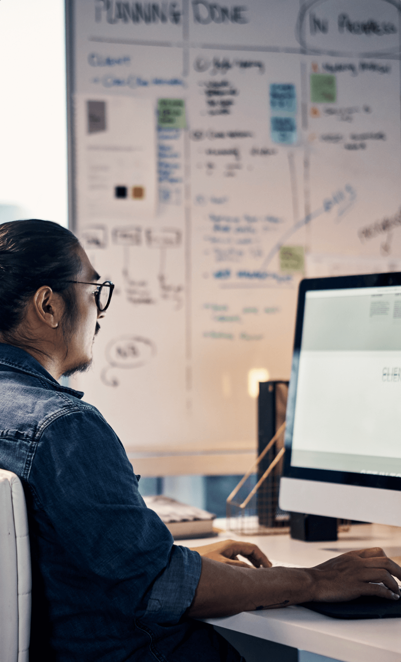 Cropped shot of a young creative businessman working on a computer in his office